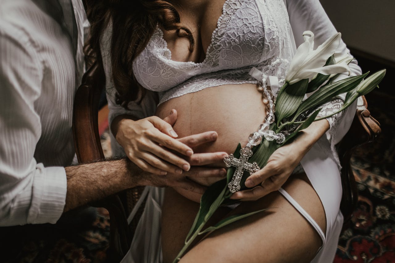 Man's Hand on Pregnant Woman's Belly